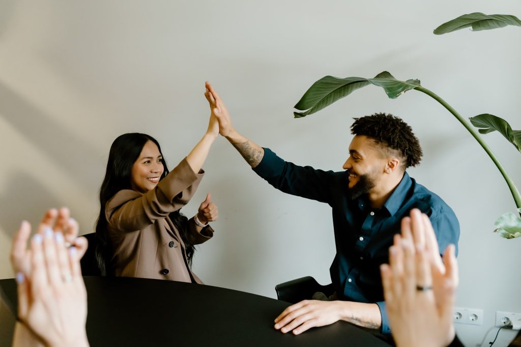 two colleagues high-fiving each other